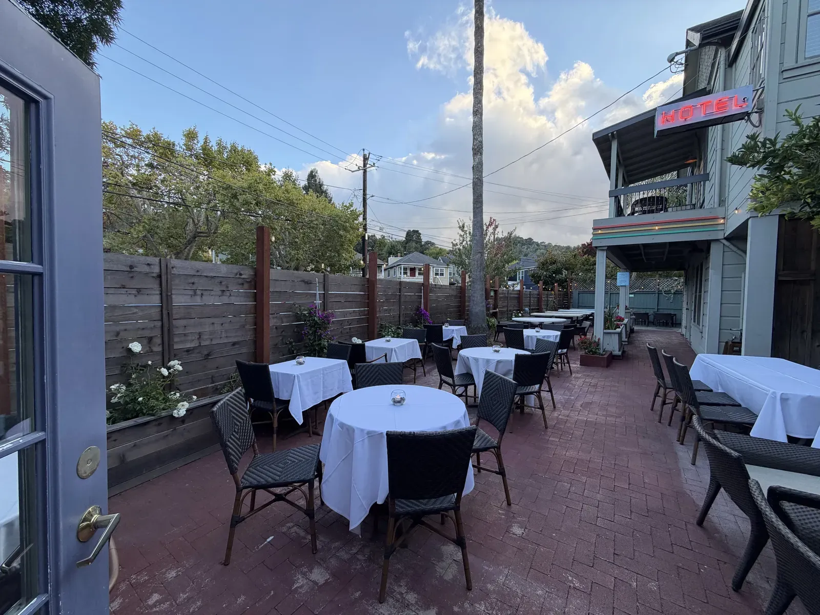 Tables set for dinner on the Panama Hotel Restaurant's garden patio